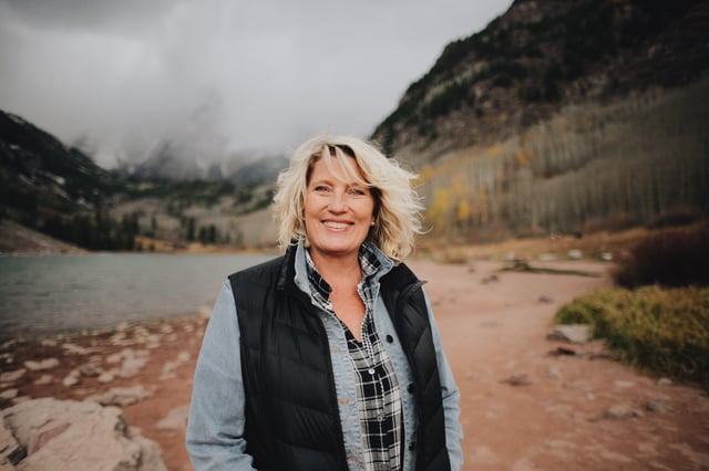 Woman smiling in front of lake