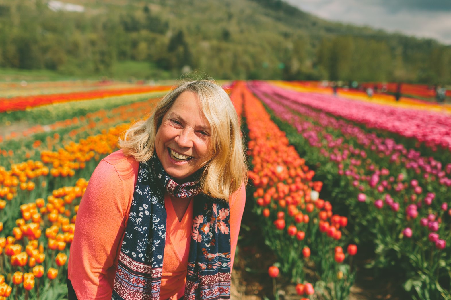 Woman laughs in field of flowers
